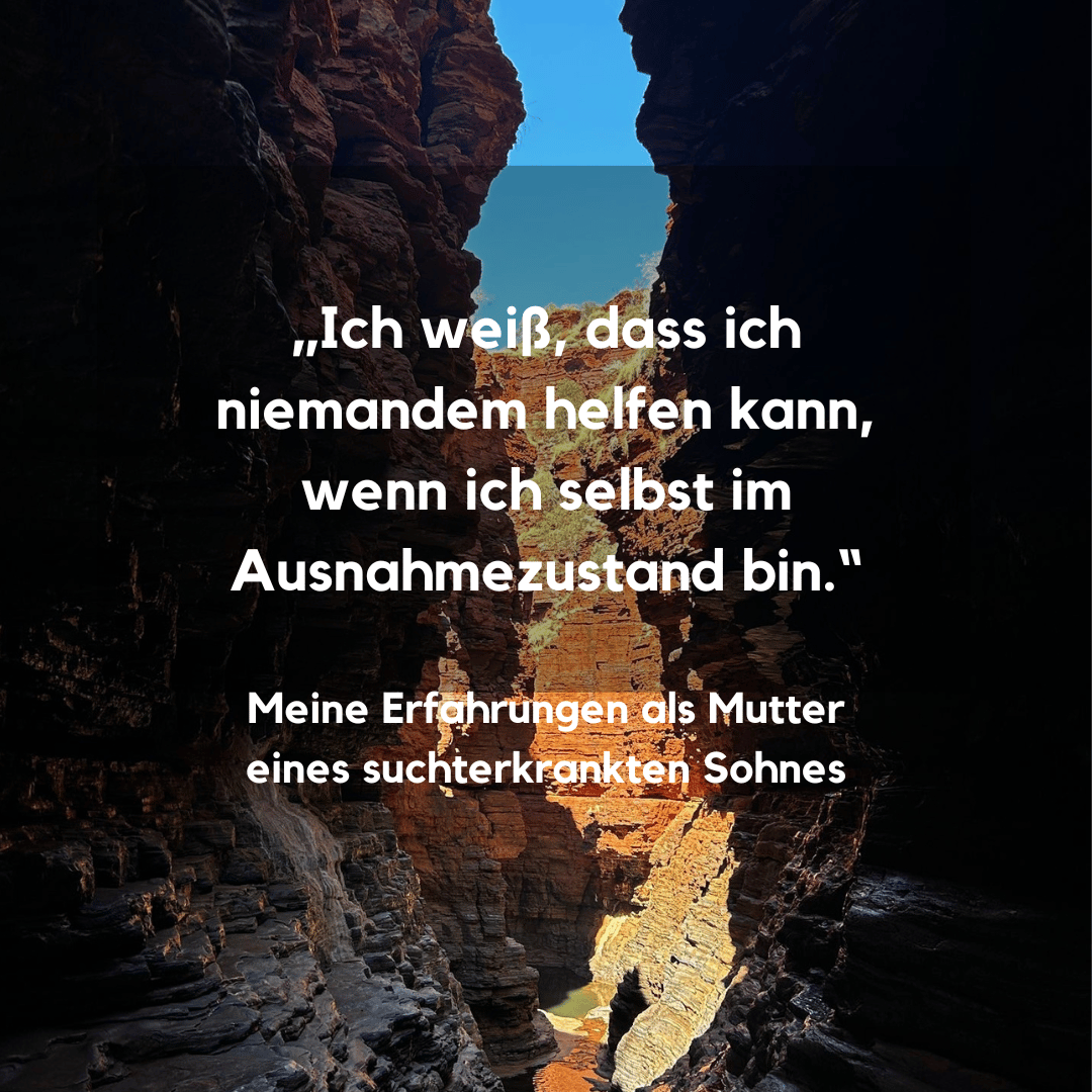 Blick aus einer dunklen Höhle über sonnenbeschienene gelbe Felsen auf das blaue Meer.